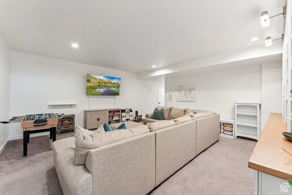 Living area featuring light carpet, recessed lighting, and baseboards