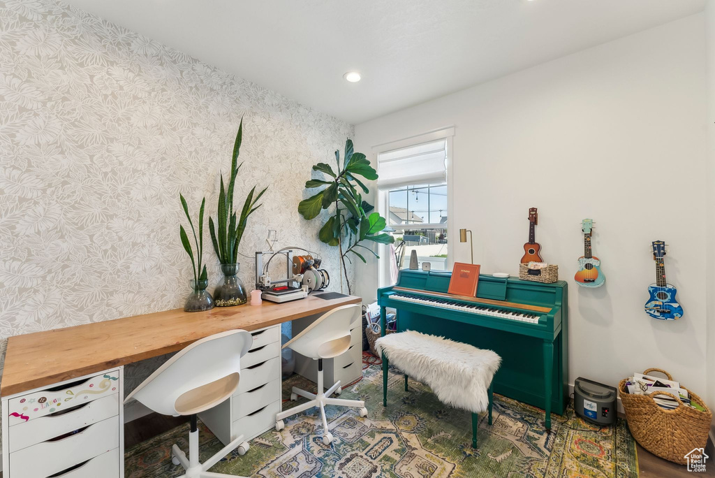 Office space featuring wallpapered walls and recessed lighting