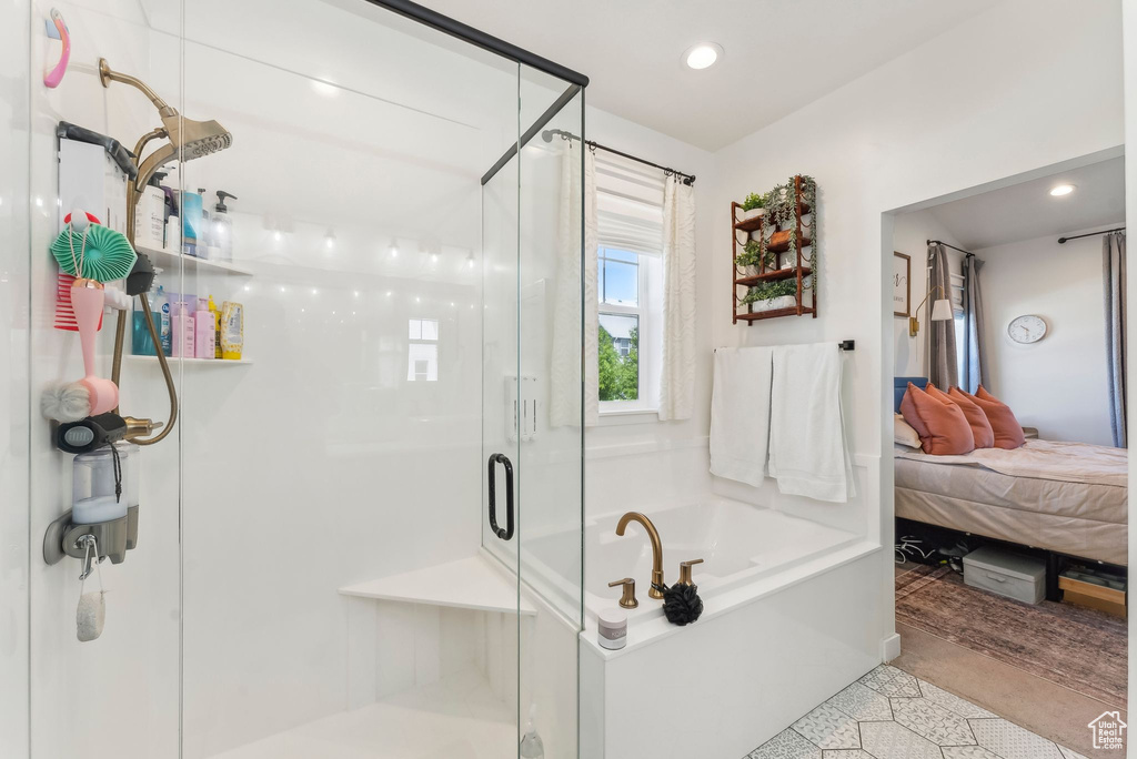 Ensuite bathroom with a shower stall, a bath, and recessed lighting