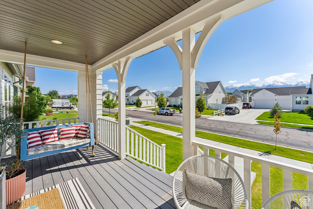 Porch featuring a residential view and a lawn