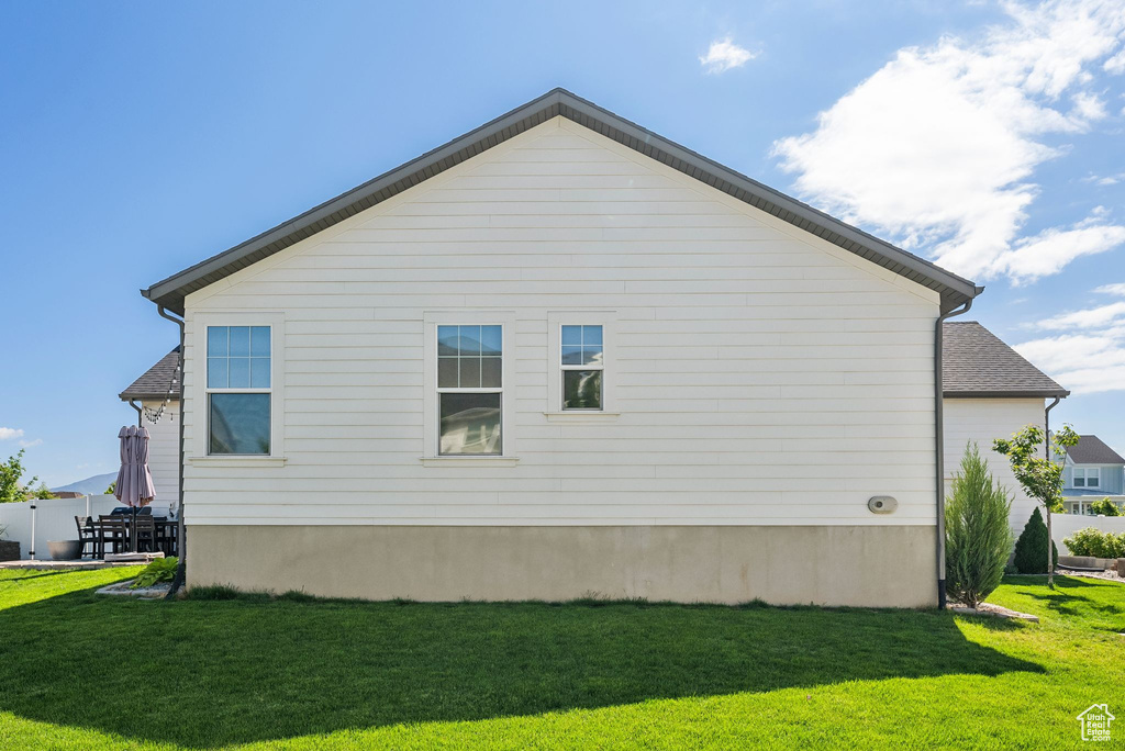 View of side of home with a lawn