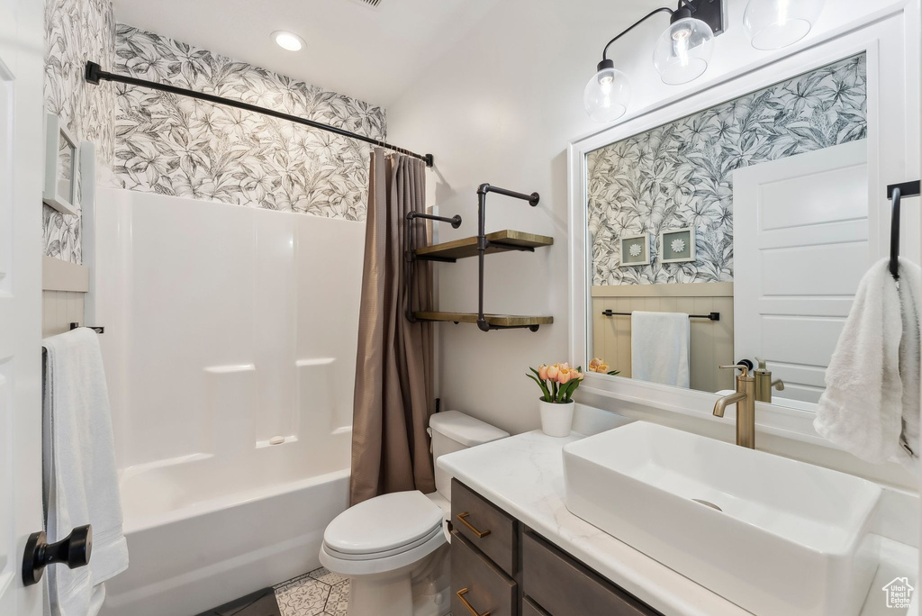 Full bathroom with toilet, shower / bath combo, vanity, and recessed lighting