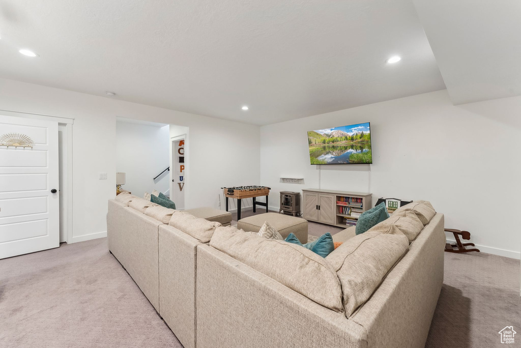 Living area with light colored carpet, recessed lighting, and baseboards