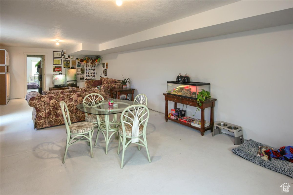 Dining area featuring a textured ceiling and finished concrete flooring
