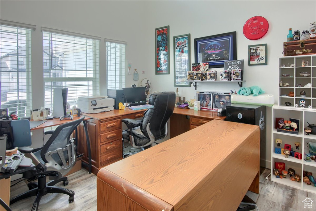 Office space featuring light wood finished floors and plenty of natural light