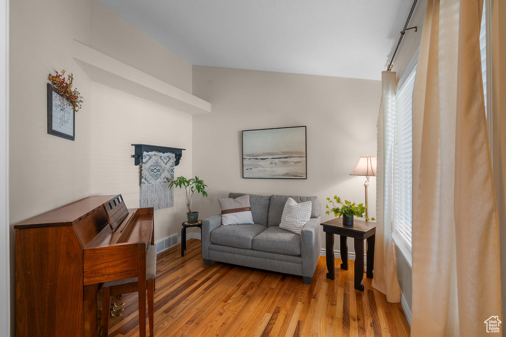 Living room featuring light wood-style flooring and baseboards