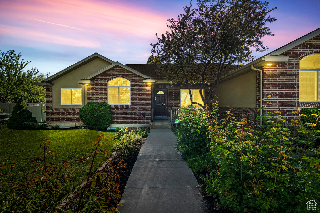 Single story home featuring brick siding and stucco siding