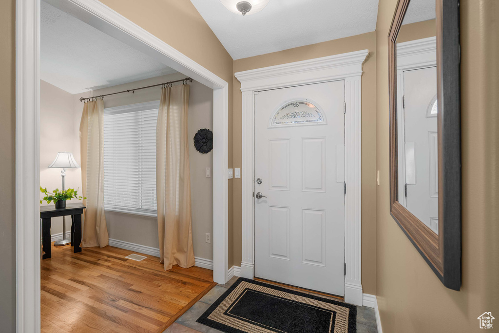 Foyer entrance with baseboards and light wood-style flooring