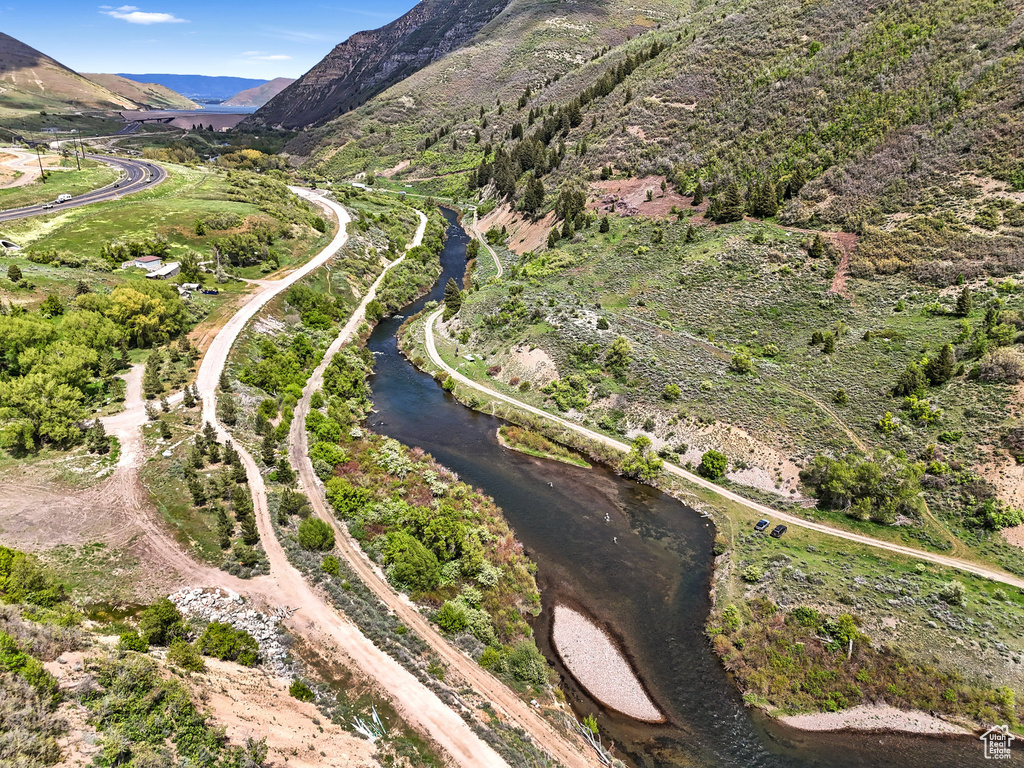 Aerial view of property and surrounding area featuring a water and mountain view