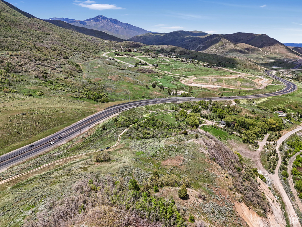 Aerial view of property and surrounding area featuring mountains