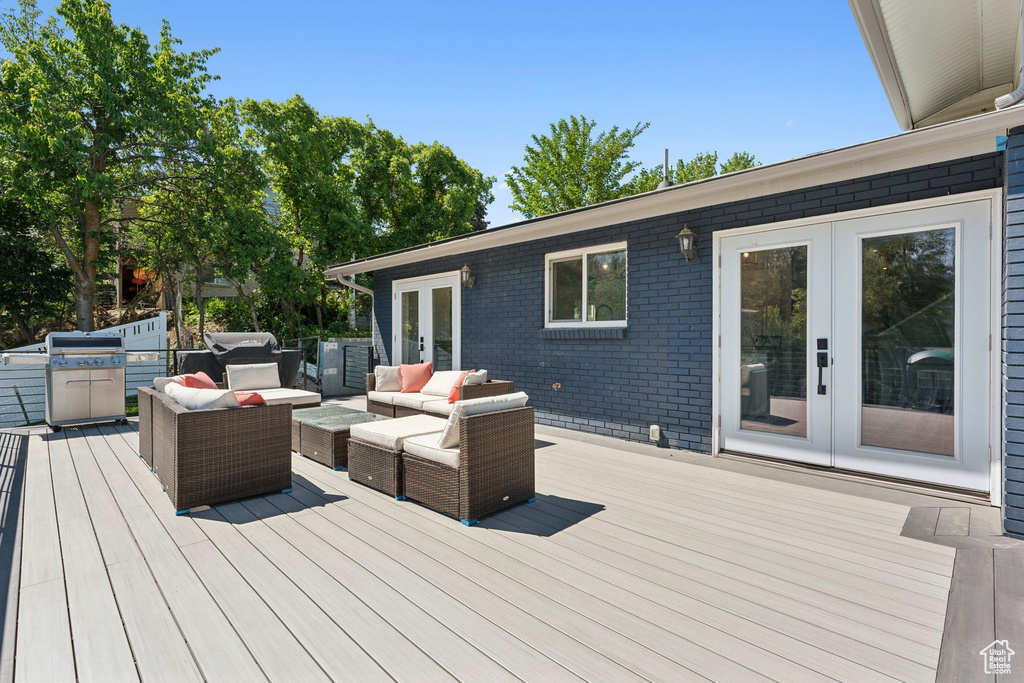 Deck with french doors, an outdoor living space, and area for grilling