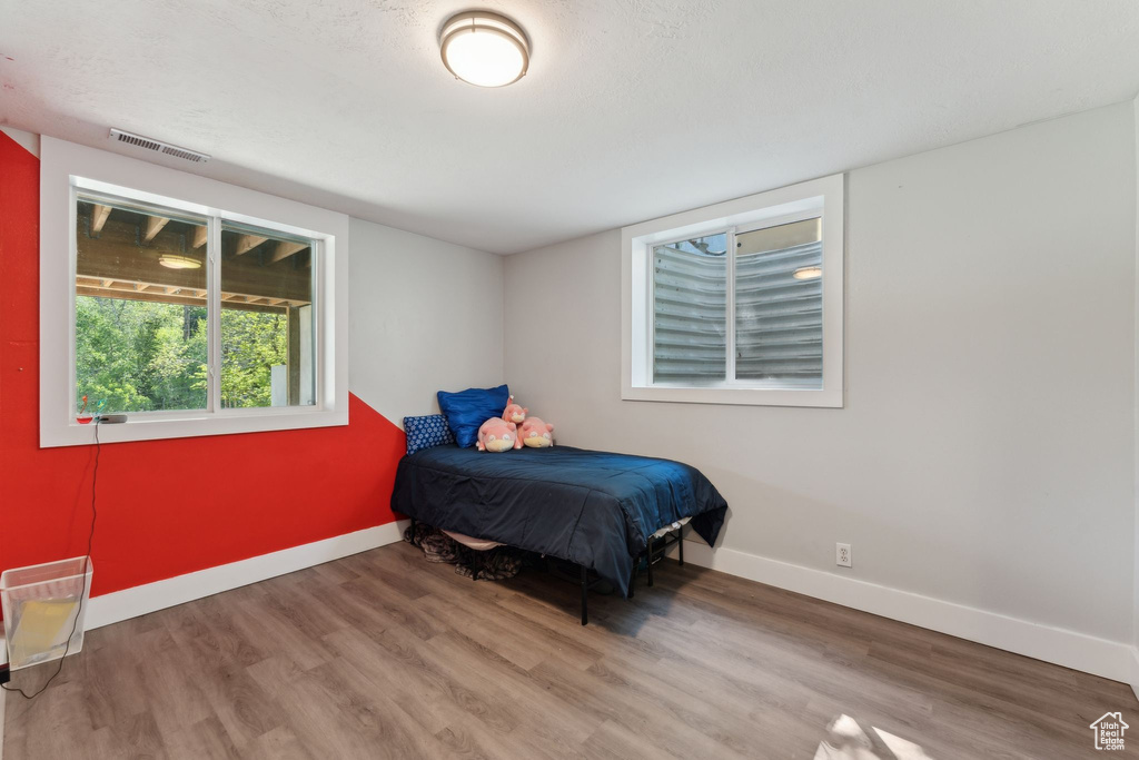Bedroom featuring wood finished floors and baseboards