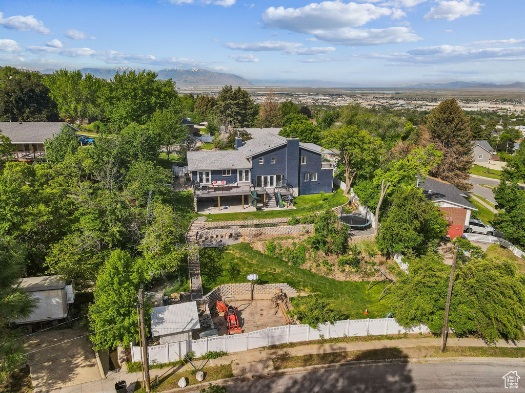 Aerial view of property and surrounding area with a mountainous background