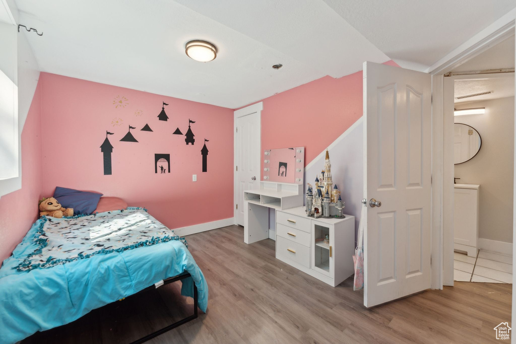 Bedroom with light wood-style flooring and baseboards