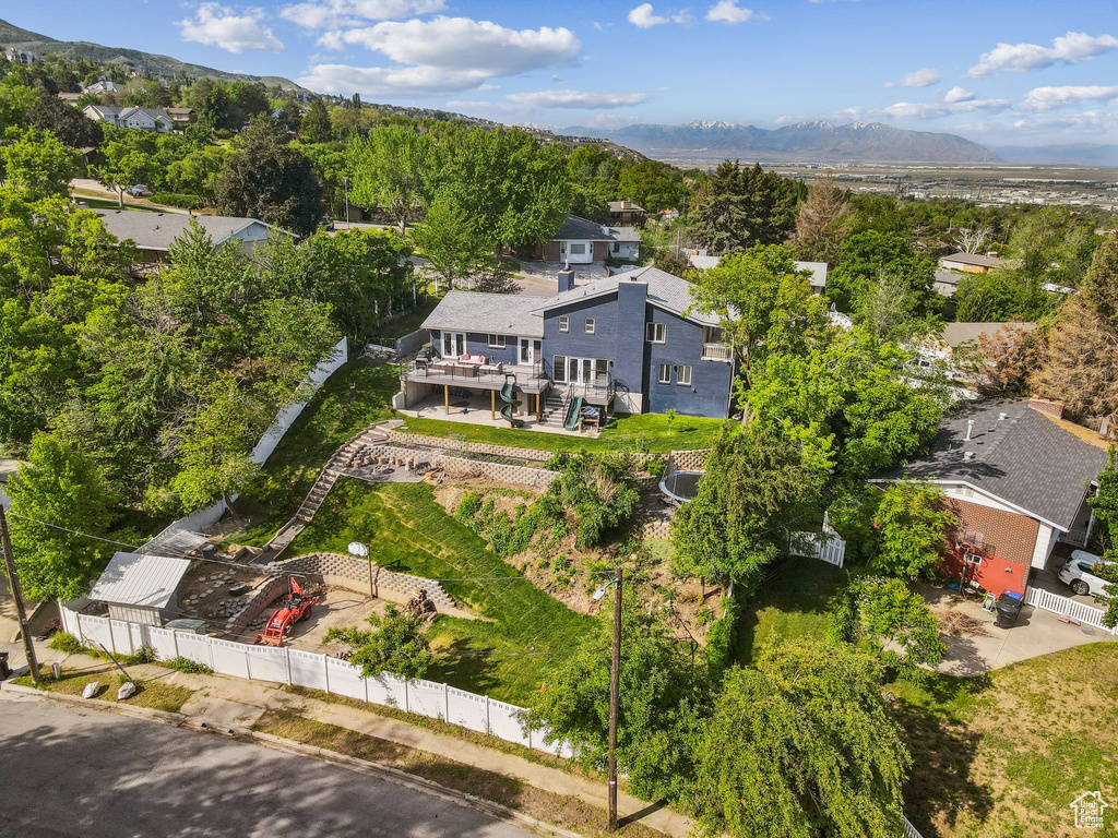 Aerial view of residential area featuring a mountainous background
