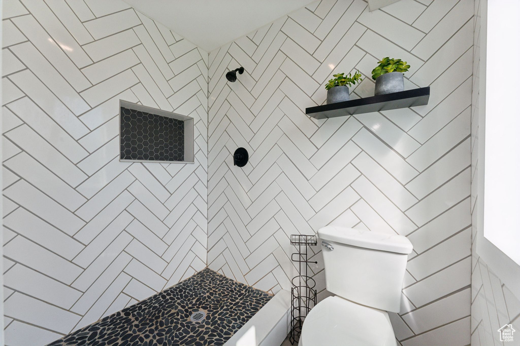 Bathroom with a tile shower and toilet