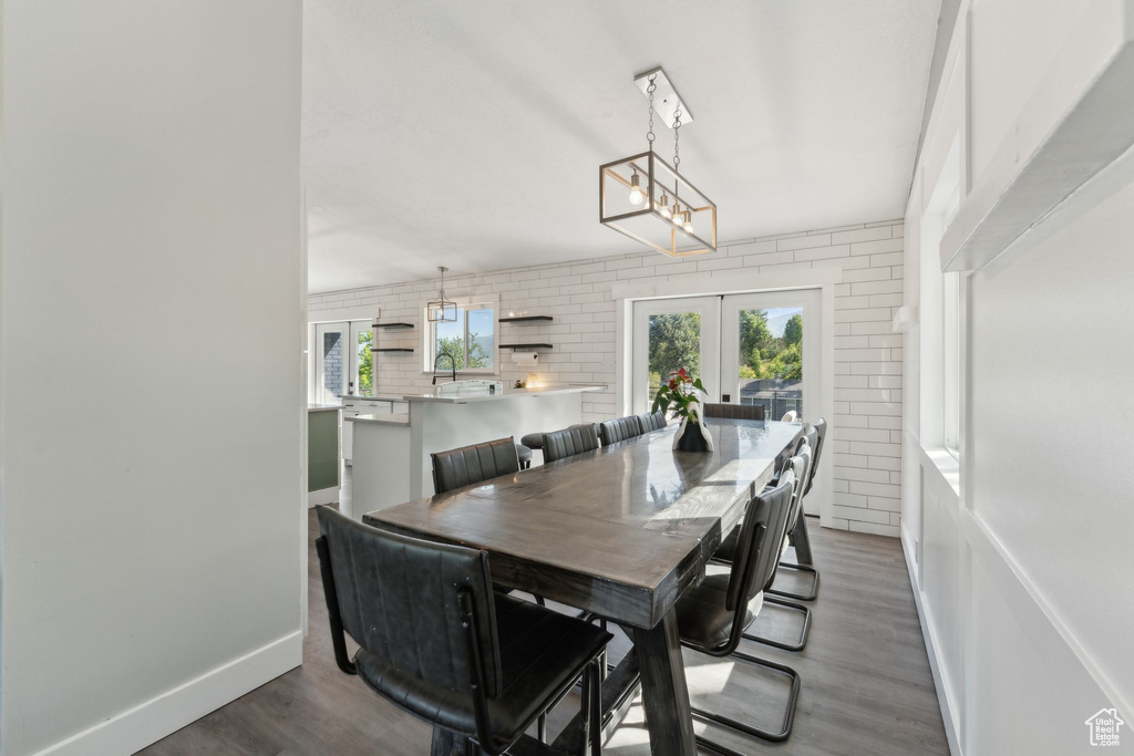 Dining room featuring french doors, wood finished floors, and baseboards
