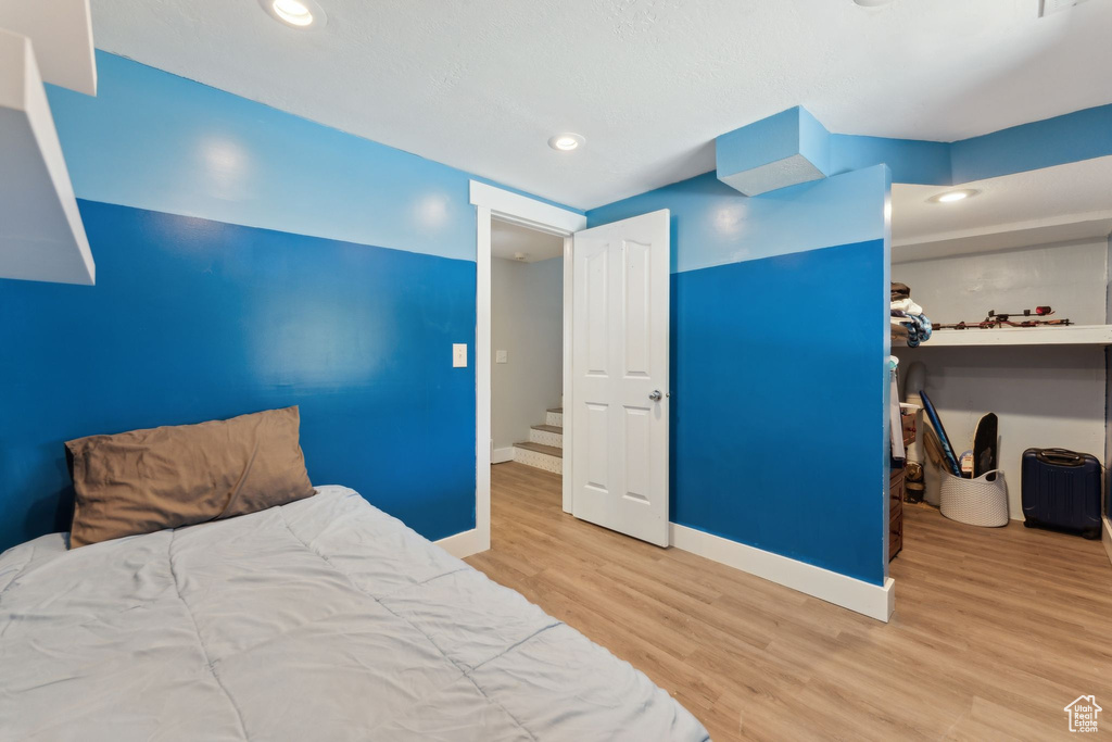 Bedroom featuring wood finished floors, baseboards, and recessed lighting