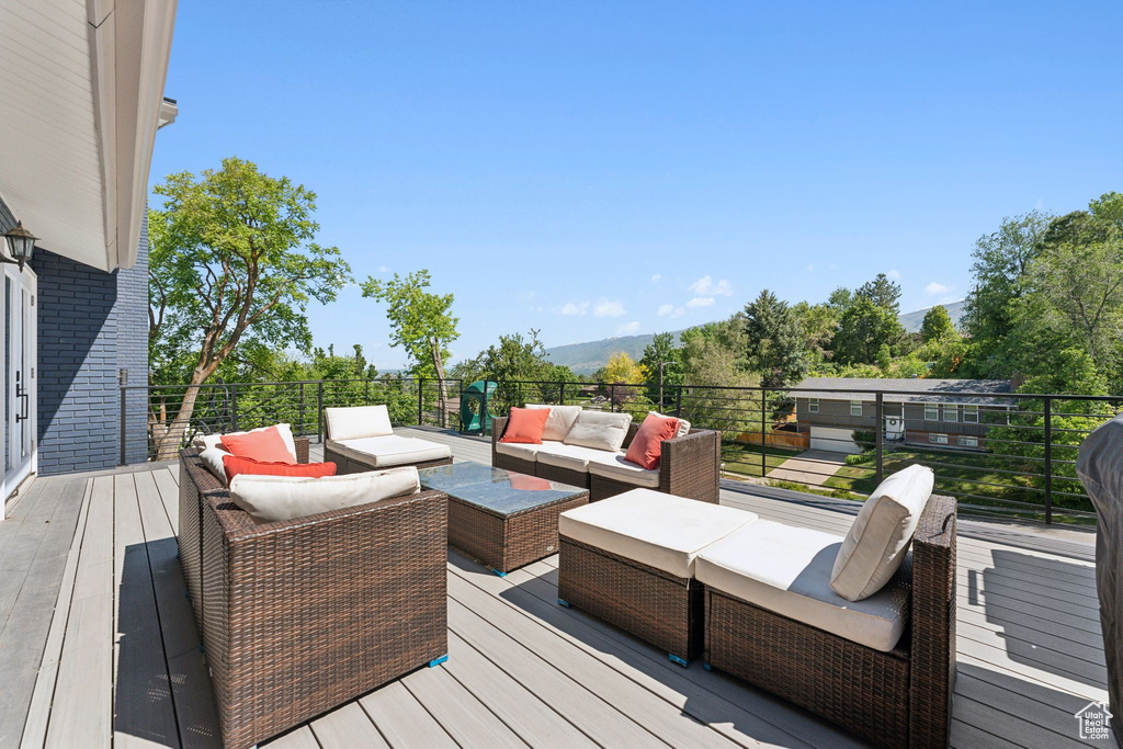 Deck featuring an outdoor living space and a mountain view
