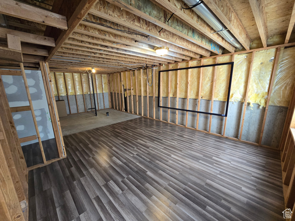 Basement featuring dark wood-style floors