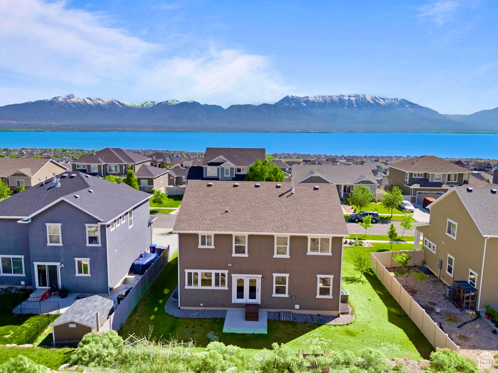 Aerial perspective of suburban area with a water and mountain view