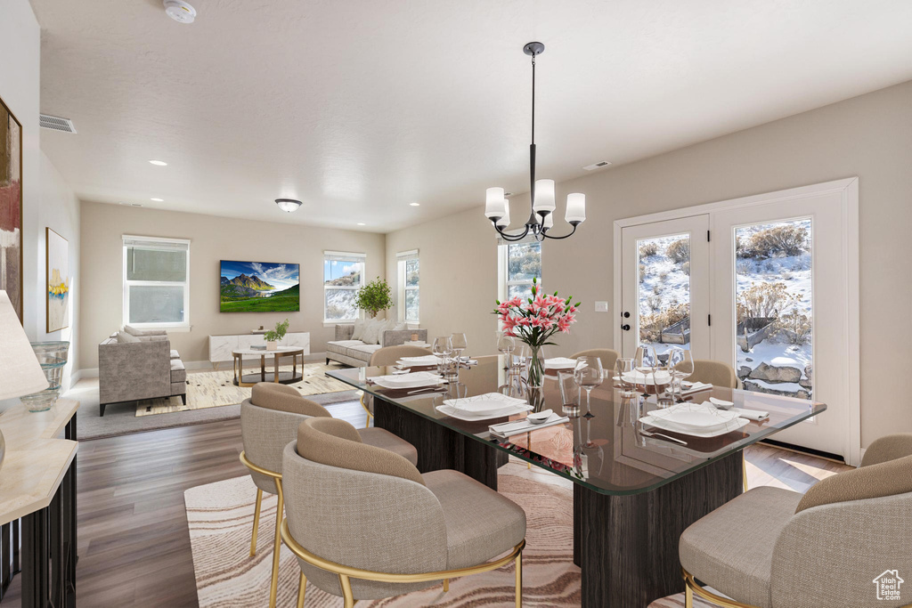 Dining room featuring wood finished floors, a chandelier, and recessed lighting