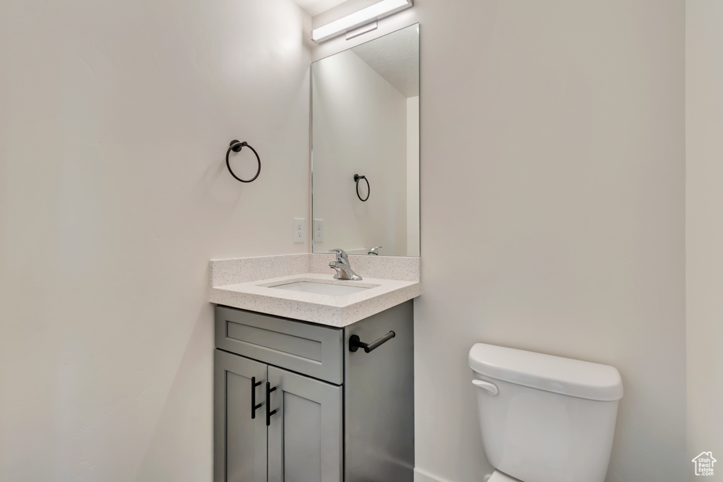 Half bathroom with toilet and vanity