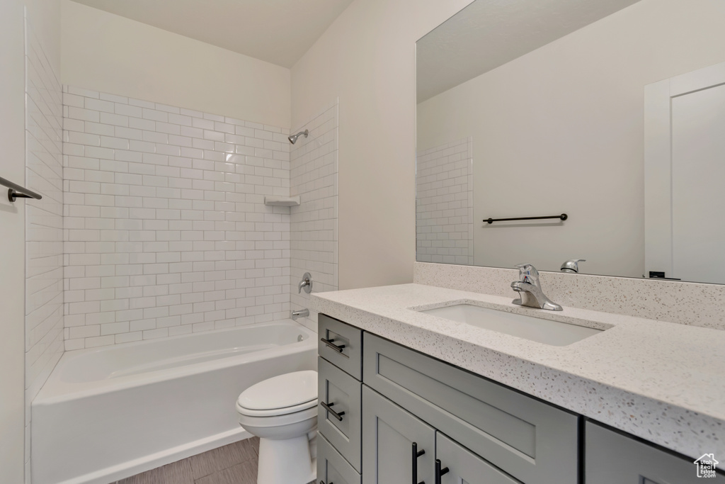 Bathroom with vanity, toilet, and bathtub / shower combination