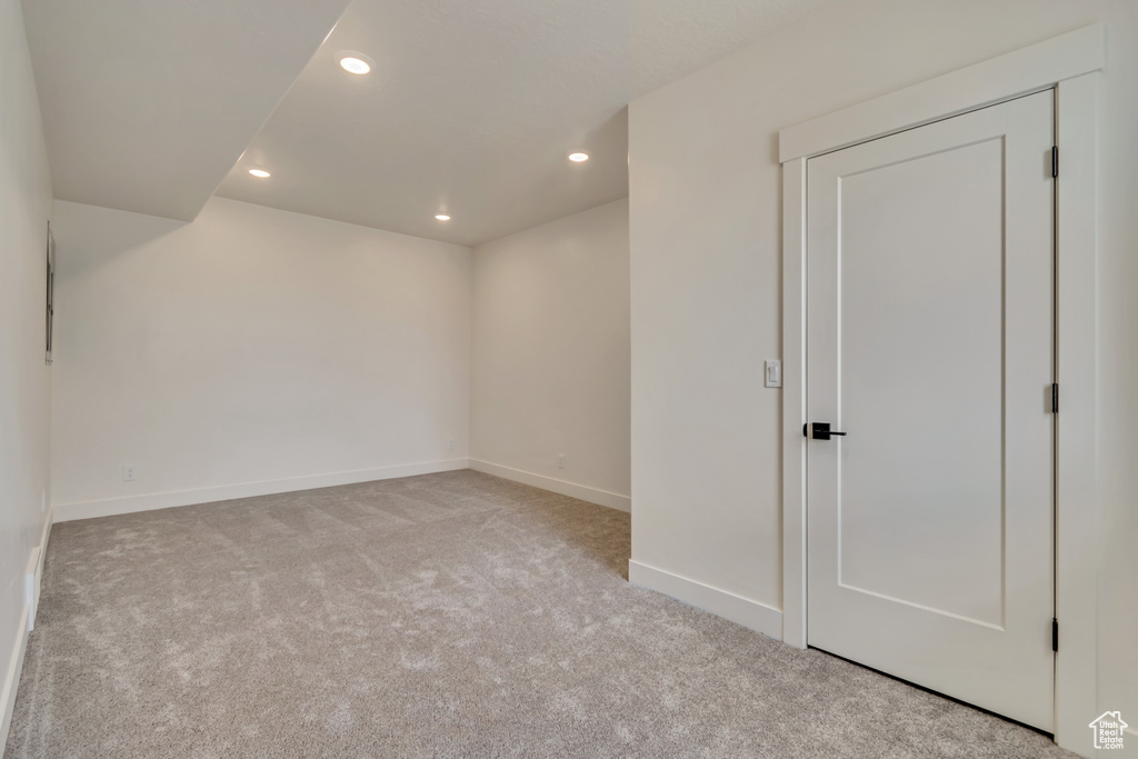 Carpeted empty room featuring recessed lighting and baseboards