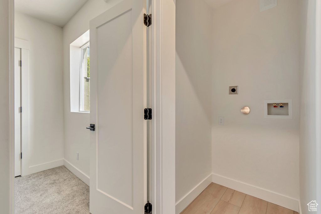 Laundry area featuring electric dryer hookup, washer hookup, and baseboards