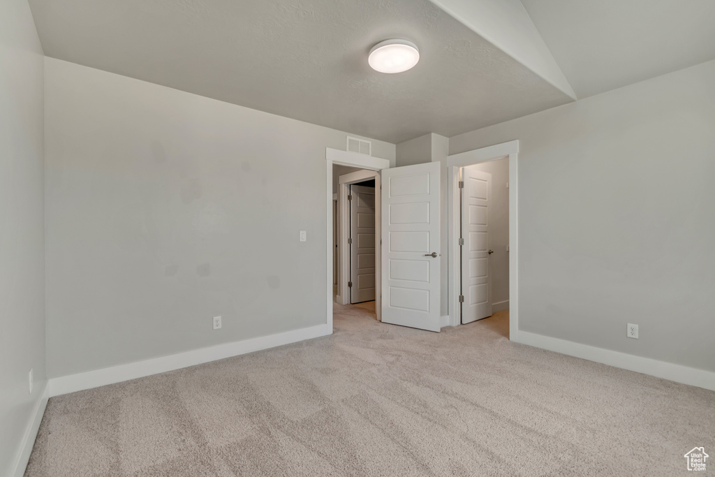 Unfurnished bedroom with carpet and baseboards