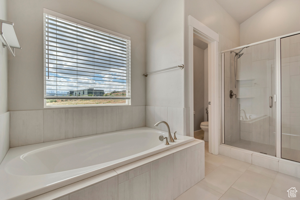 Full bath with toilet, a garden tub, a stall shower, and tile patterned floors