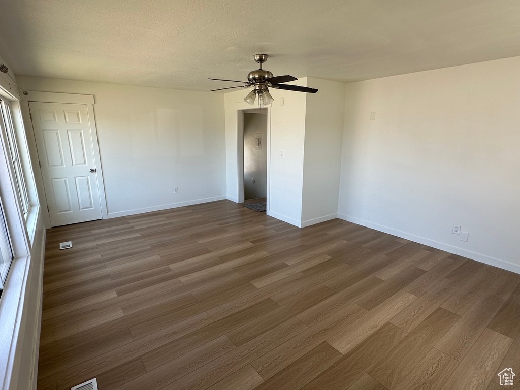 Unfurnished room with wood finished floors and baseboards