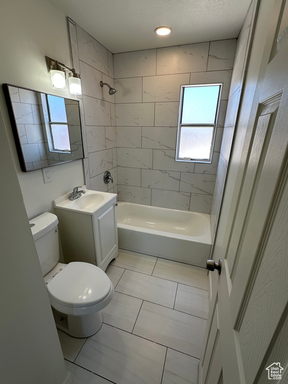 Bathroom with toilet, vanity, and bathtub / shower combination