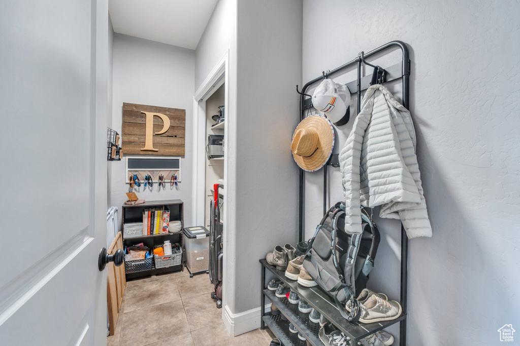 Mudroom with tile patterned flooring