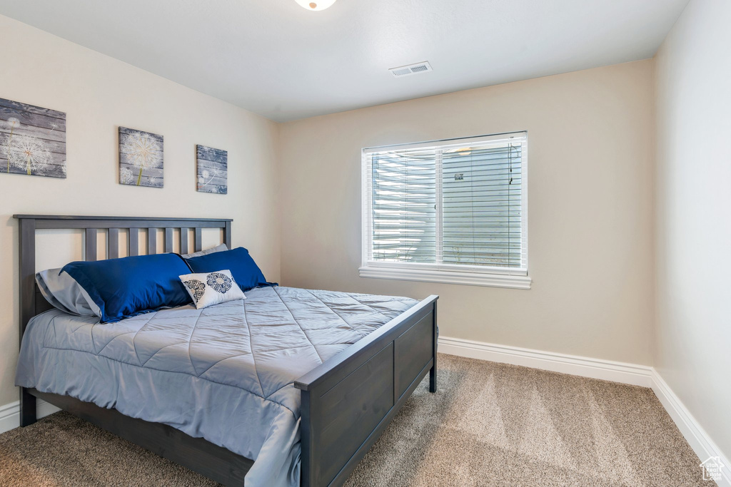 Bedroom with baseboards and carpet floors