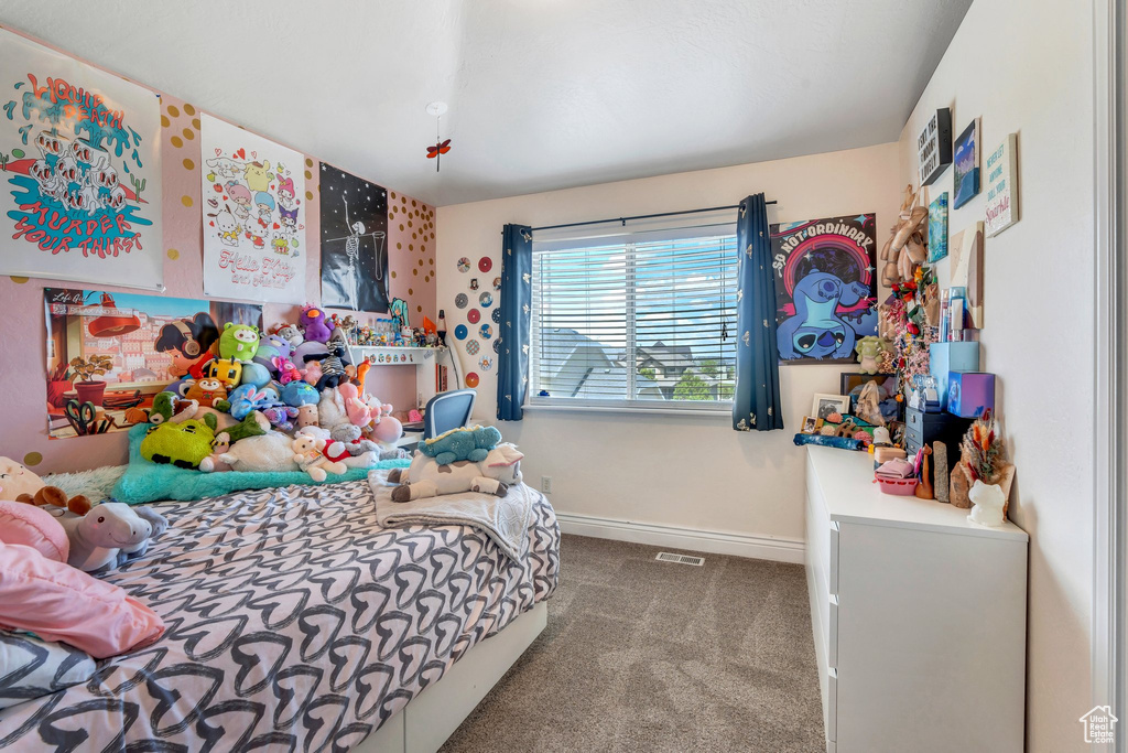 Bedroom featuring carpet floors and baseboards
