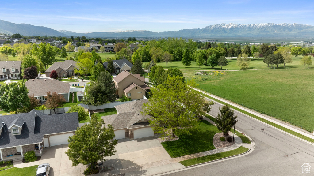 Aerial perspective of suburban area featuring a mountain backdrop