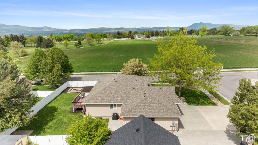 Aerial view of property and surrounding area featuring mountains