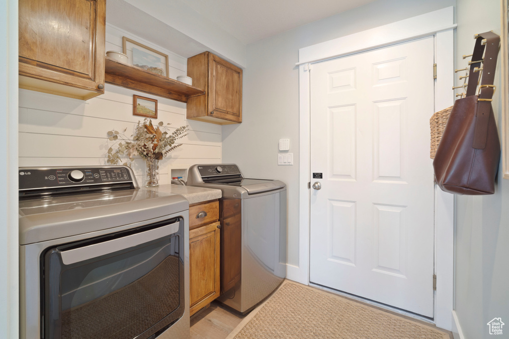 Washroom with cabinet space and independent washer and dryer