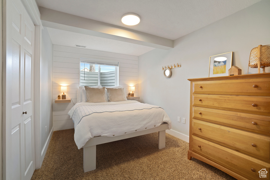 Carpeted bedroom with baseboards