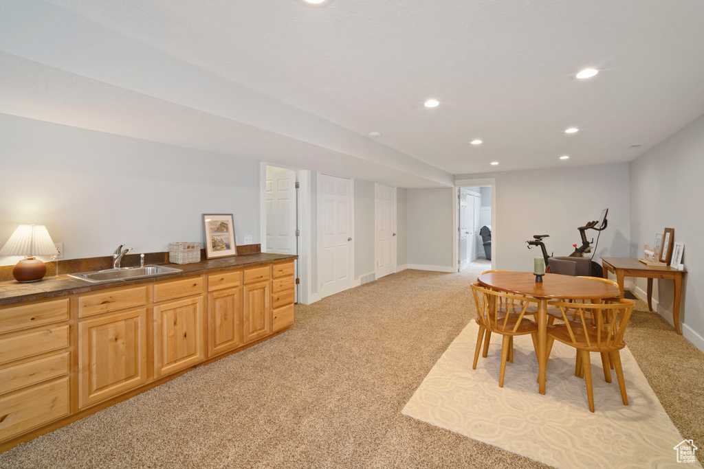 Dining room with light colored carpet, recessed lighting, and baseboards
