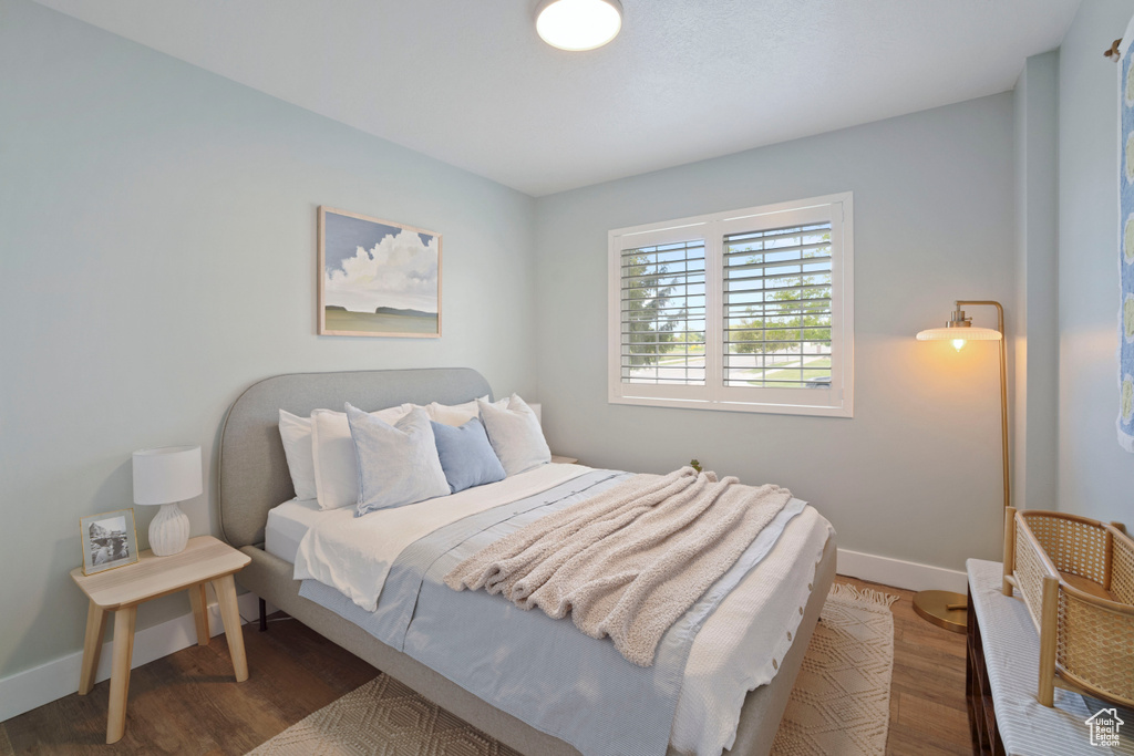 Bedroom featuring wood finished floors and baseboards