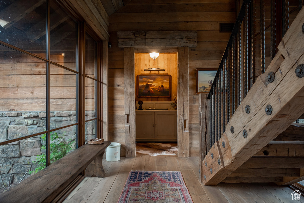 Wine cellar with wooden walls and hardwood / wood-style floors