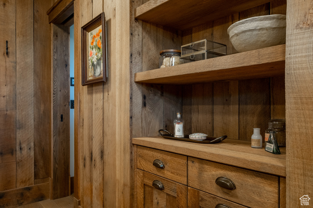Wine cellar featuring wood walls