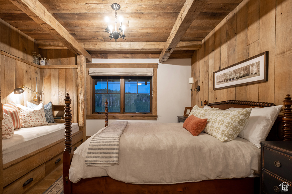 Bedroom with wooden walls, wooden ceiling, beamed ceiling, and wood finished floors