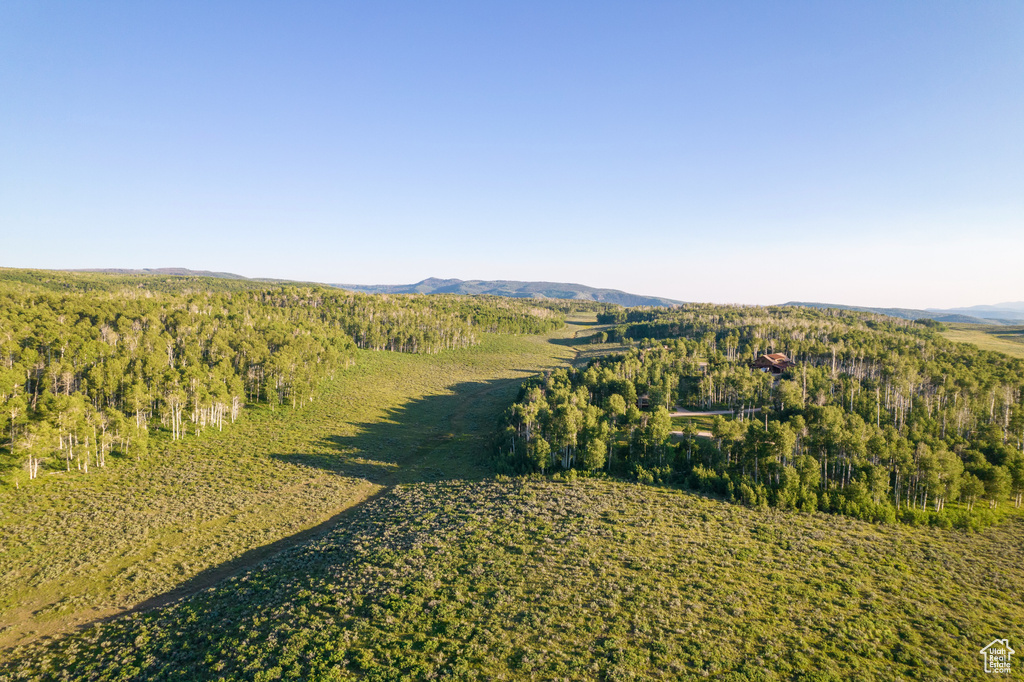 View of property location featuring a heavily wooded area and mountains
