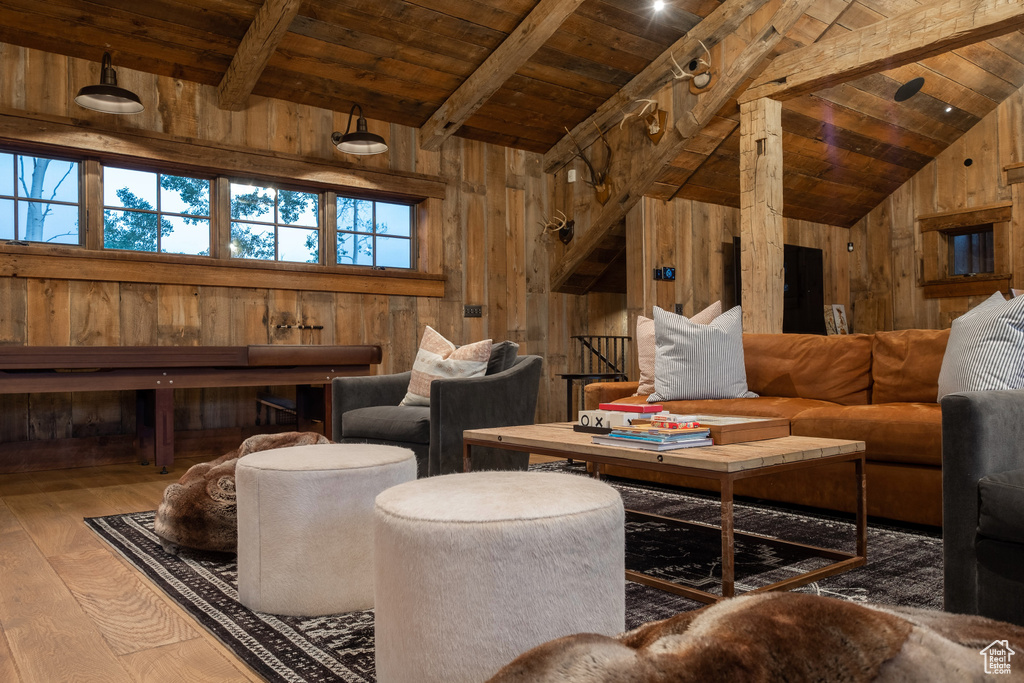 Living area with wood walls, wood-type flooring, and wooden ceiling