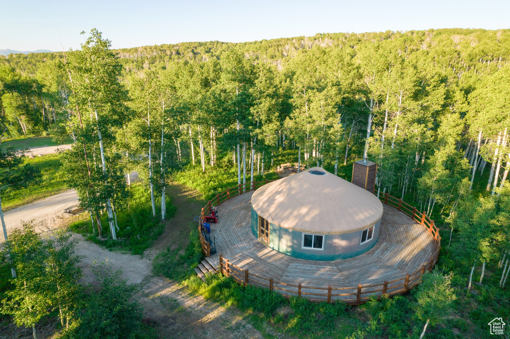 Aerial view of property and surrounding area featuring a heavily wooded area