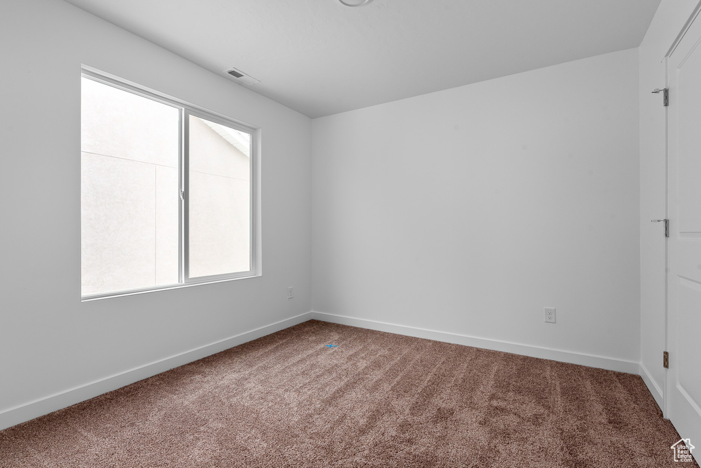 Unfurnished room with carpet flooring and baseboards